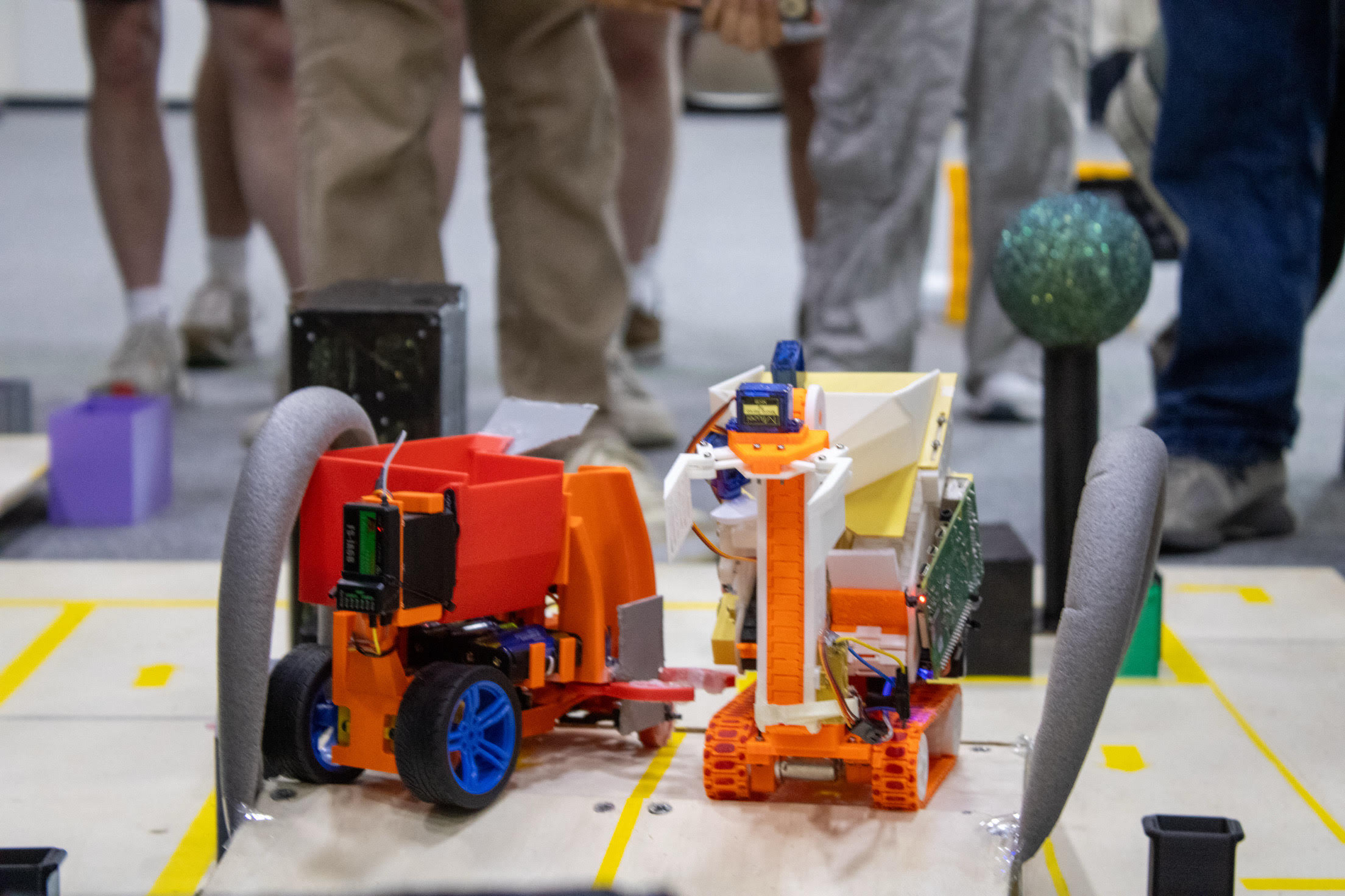Robot navigating the competition course, positioned on a ramp between obstacles