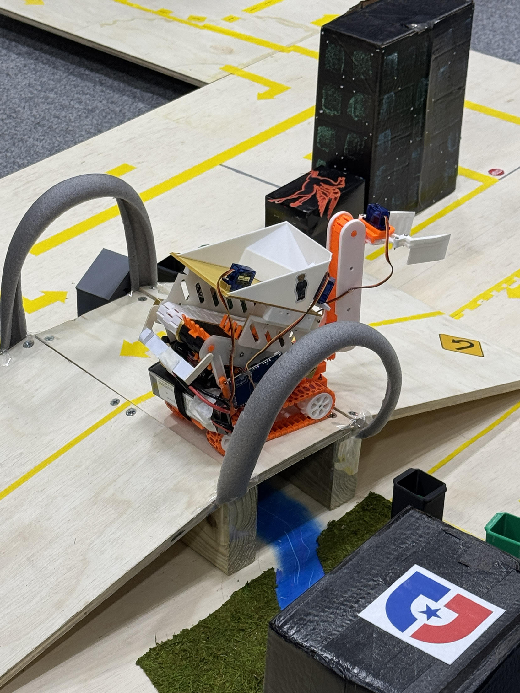 Two competing robots side by side on the arena floor before a head-to-head match